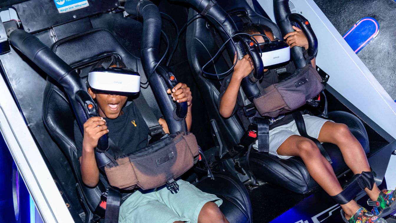 Two teenagers playing a virtual game at Enzo Reality in Lagos, Nigeria.