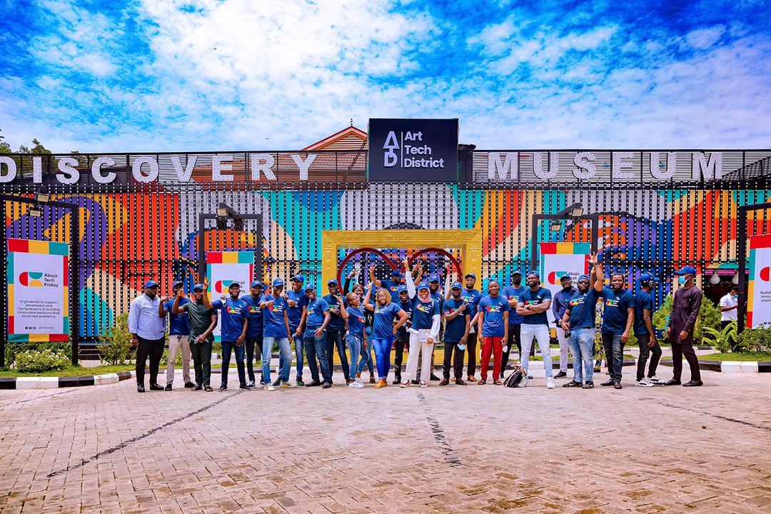 A group of visitors standing outside the Discovery Museum in Abuja