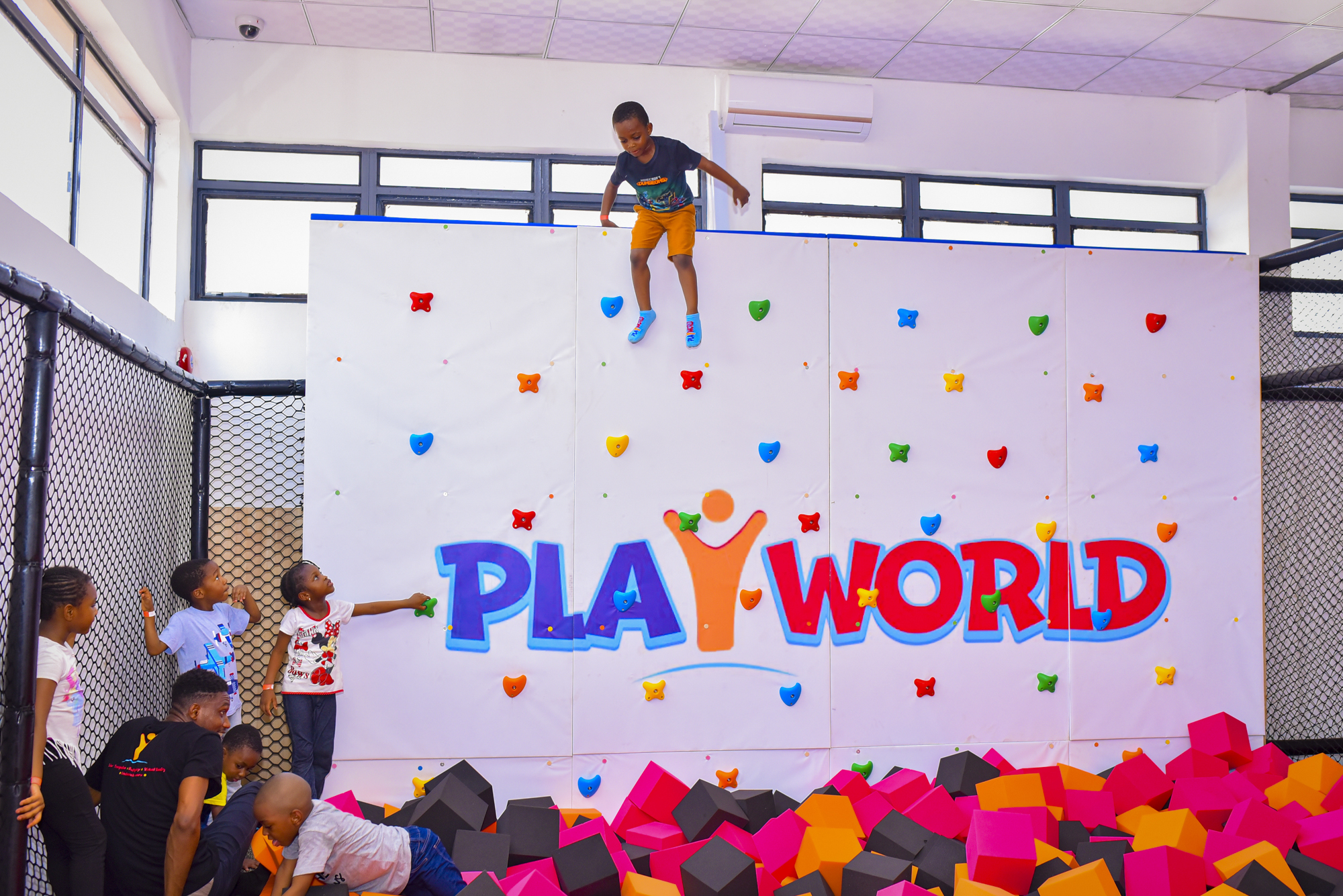 A child jumping down a structure in PlayWorld Jabi