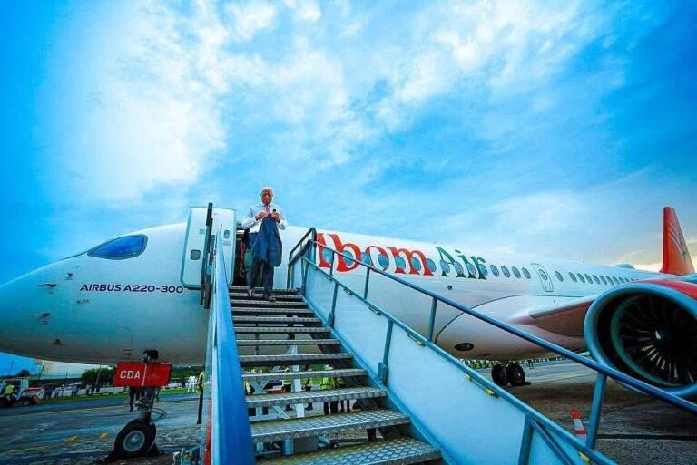 Governor Umo Eno walking down Ibom Air's flight of stairs.